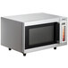 A Galaxy stainless steel microwave with a glass door.