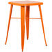 an orange stool with legs