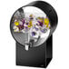 A black circular beverage dispenser with flowers inside.