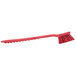 A red Carlisle Sparta pot scrub brush with a long handle.