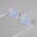 Clear plastic hinged lids for a Cal-Mil condiment holder on a white surface.