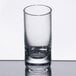 A Stolzle New York shot glass on a reflective surface.