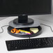 A black Kensington monitor stand with a computer monitor and keyboard on it.