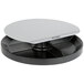 A black and gray Kensington Spin2 monitor stand on a table in a white room.