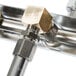 A T&S brass wall mount faucet with a metal pipe and spray nozzle.
