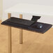 A black Kensington underdesk keyboard tray with a keyboard and mouse on it.
