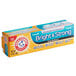A yellow and blue box of Arm & Hammer Truly Radiant Bright and Strong toothpaste on a counter.