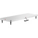 A white rectangular Nemco heated shelf warmer with stainless steel sides on a black rectangular object.