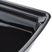 A black Cambro rectangular ribbed bowl with a lid.