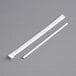 Two white plastic Choice slim sip straws on a gray surface.