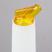 A yellow plastic Carlisle Store 'N Pour container with a white cap and yellow spout.