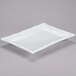 A white rectangular porcelain platter with a white rim.