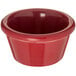 A red bowl sitting on a table.