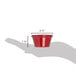 A hand holding a red Carlisle melamine ramekin with measurements.