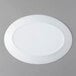 An Arcoroc white oval platter on a gray surface.