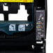 The inside of a black San Jamar Smart System paper towel dispenser with a yellow label.