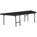 A National Public Seating rectangular portable stage pie unit with black carpet on top.