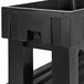 A black plastic IRP ice bin with a lid on a table.