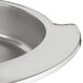 A close-up of a stainless steel bowl with a handle.