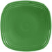 A close up of a green square Fiesta salad plate with a white circle in the middle.