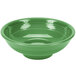 A green bowl with a white stripe on a circular pedestal.