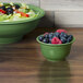 A bowl of salad with blueberries and raspberries.