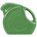 A green Fiesta mini disc creamer pitcher with a handle.