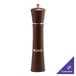 A brown pepper mill with silver trim and a wooden handle.