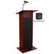 A mahogany Oklahoma Sound power plus lectern with a microphone and speaker.