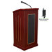 A mahogany wooden Oklahoma Sound lectern with a microphone and speaker.