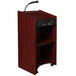 A mahogany wooden lectern with a microphone and speakers.