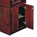 A mahogany and walnut combination floor lectern with a book on top.