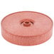 A red polyethylene circular tortilla server with a hole in the center.
