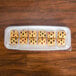 A clear plastic tray of cookies on a table.