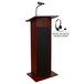 A mahogany podium with a microphone and speaker stand.