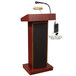 A mahogany podium with a wireless microphone and speaker.