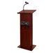 A mahogany wooden podium with a microphone.