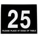 A black Cal-Mil table tent with white numbers displaying "25"