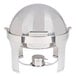 A Vollrath stainless steel round chafer with a round lid with brass trim.