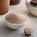 A bowl of Bossen Okinawa Milk Tea powder with a spoon.