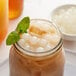 A glass jar of iced tea with Bossen Yogurt Bursting Boba and mint leaves.