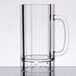 A clear plastic beer mug with a handle.