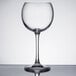 A Chef & Sommelier clear wine glass with a long stem on a table.