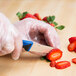 a person cutting a strawberry