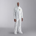 A man in white Cordova coveralls with elastic wrists, a hood, and boots.