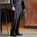 A close-up of a man wearing black Henry Segal dress pants.