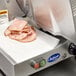 A Globe Chefmate meat slicer with ham on the machine.