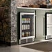 A stainless steel and glass door beverage cooler built into a kitchen or bar counter.
