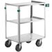 A Regency stainless steel utility cart with three shelves and wheels.