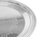A close up of a Vollrath stainless steel round fluted tray.